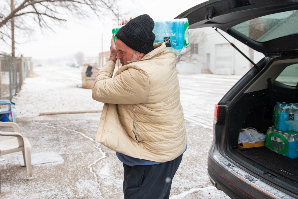 Tony Foster, a volunteer at the Code Blue Warming Station in Amarillo, brought in cases of bottled water to the shelter on Friday.