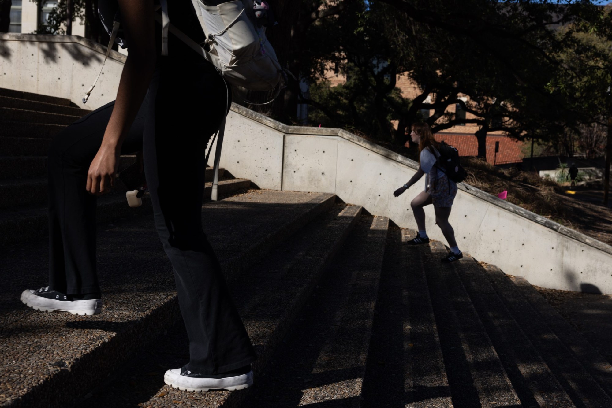Students walk up the steps toward the UT Tower on Feb. 22, 2024.