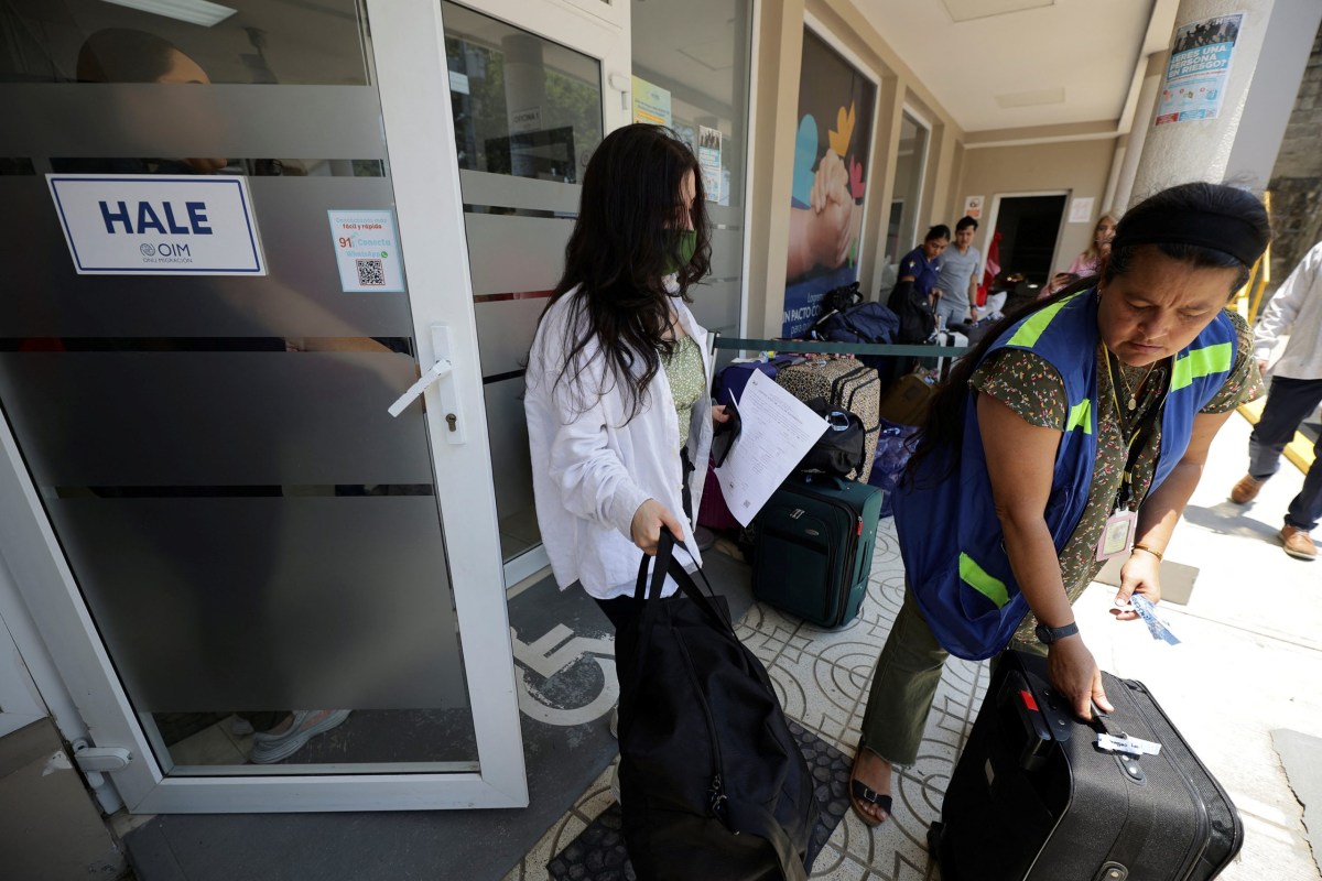 Honduran migrants who voluntarily returned to their home country using the CBP Home app — part of a Trump administration initiative encouraging self-deportation of undocumented immigrants — are assisted by staff at the Center for Attention to Returned Migrants in San Pedro Sula, Honduras on May 19, 2025.