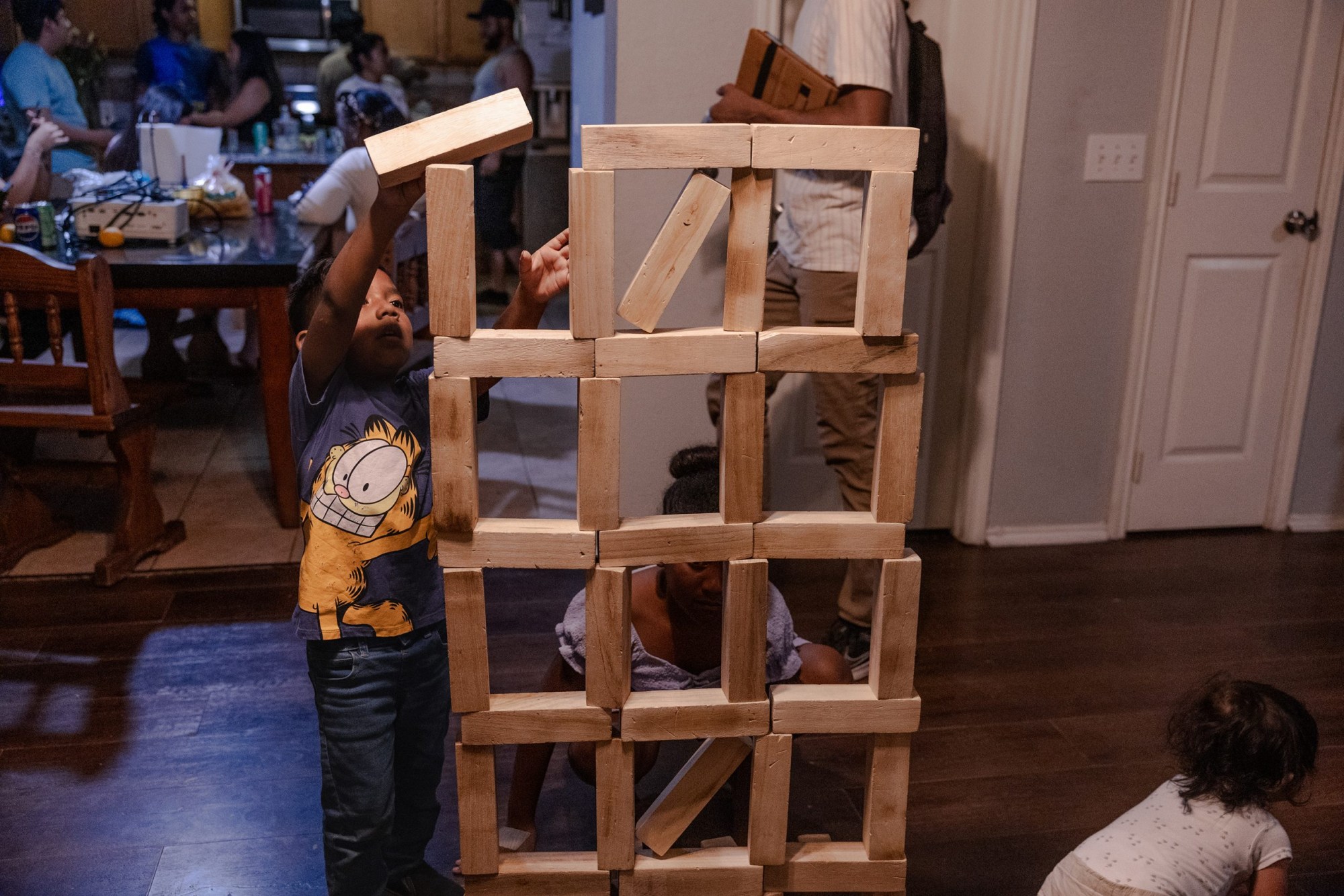 The Avila grandchildren build a Jenga version of the detention facility where their grandmother, Margarita, was being held in May.