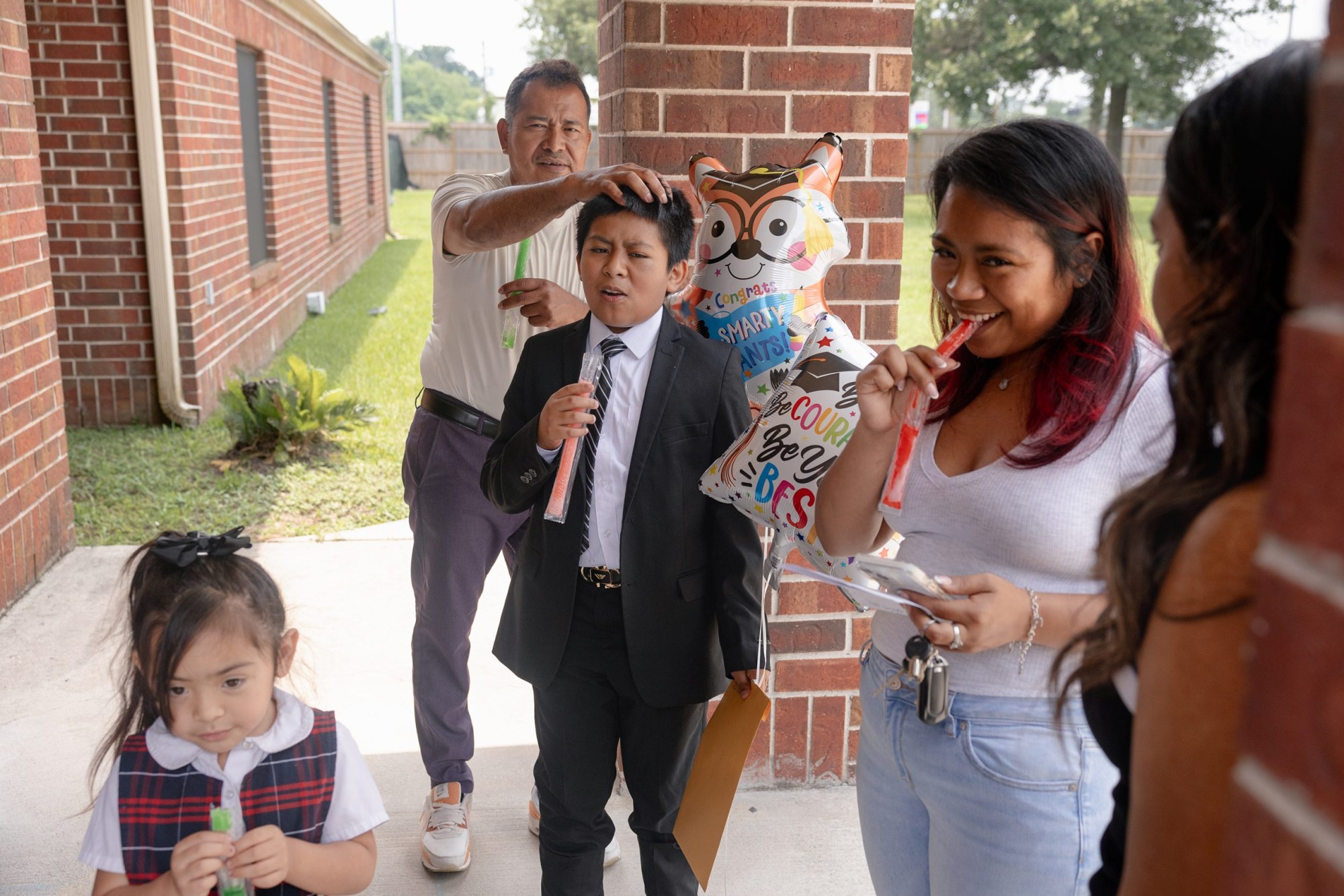 The Avila family hangs outside after Jeremiah’s graduation ceremony.