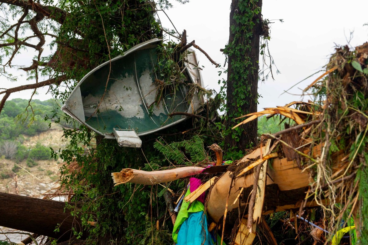 A small boat is wrapped around a tree along with other debris in Ingram on Saturday, July 5, 2025. Ingram is a small town about seven miles northwest of Kerrville.