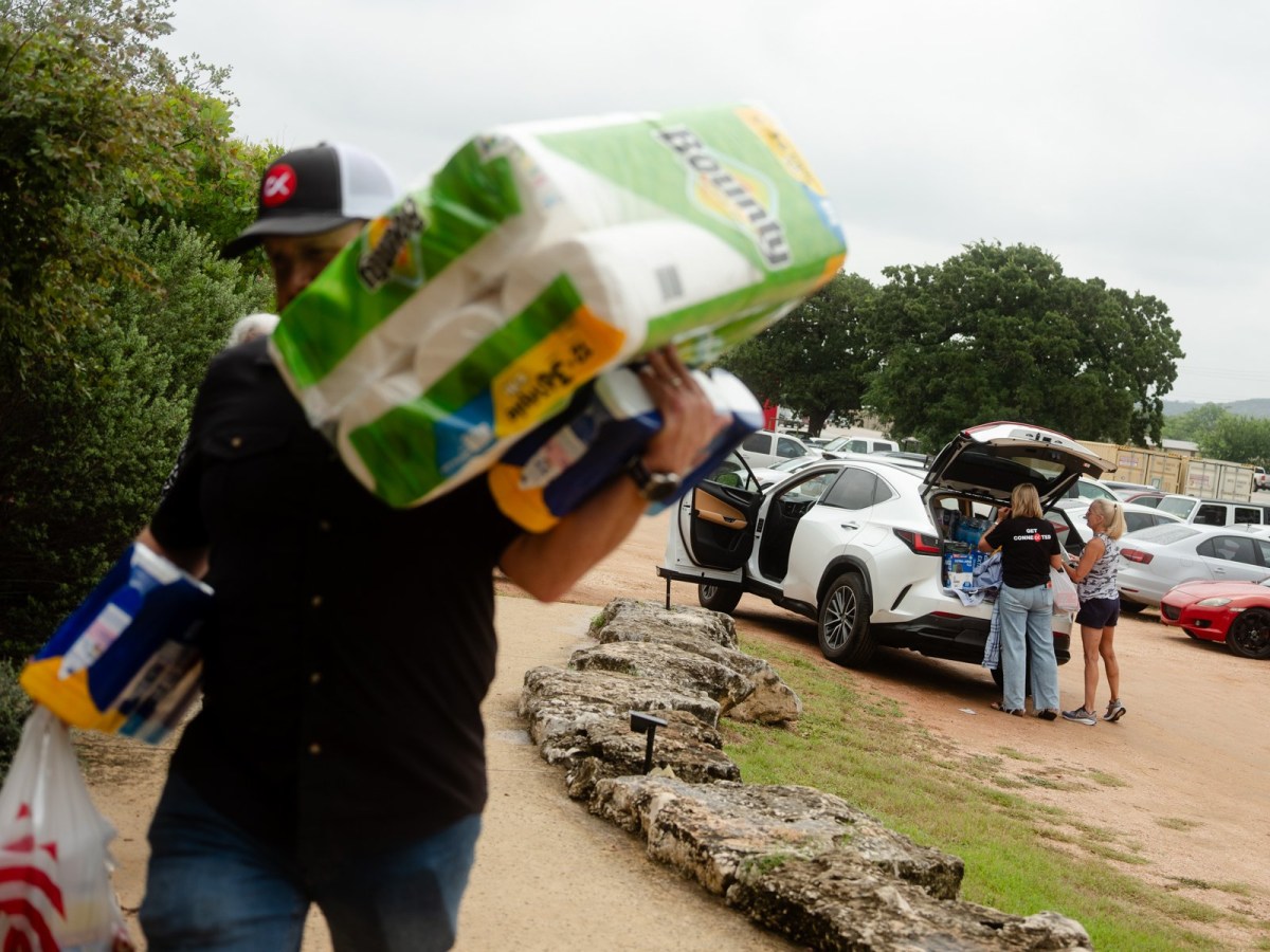 Community members sort donations to help victims of the flood at the Cross Kingdom Church in Kerrville during the first Sunday service after the floods on July 6, 2025.