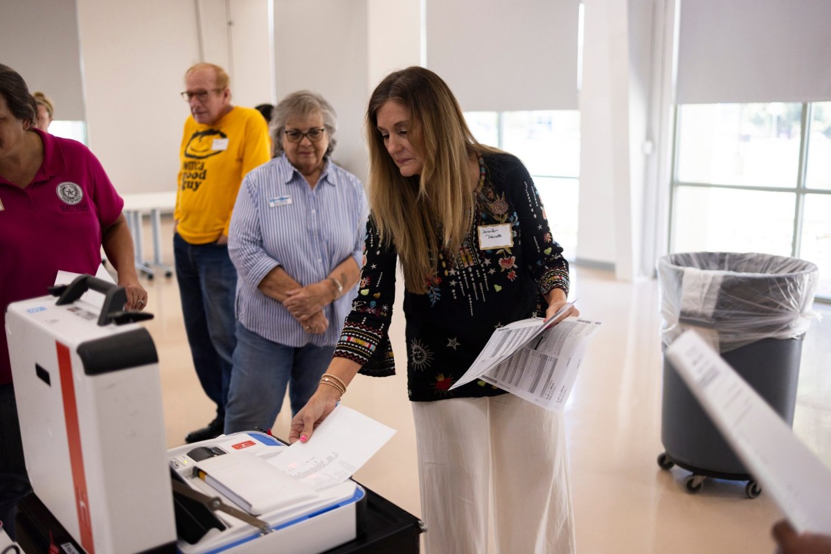 Hays County elections administrator Jennifer Doinoff assists people testing polling equipment at the Hays County election office on Sept. 18, 2024.