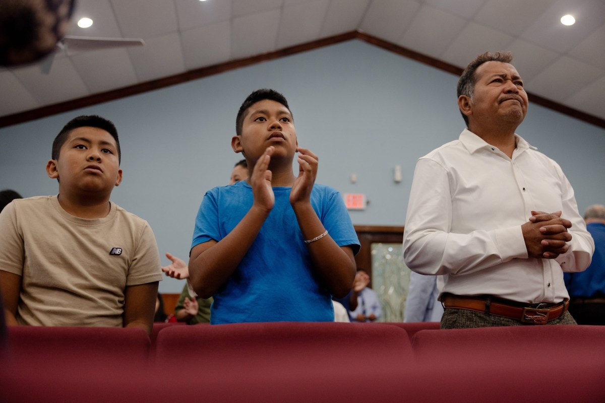 José Avila and his sons, Jeremiah (left) and Issac (middle), attend service at their Houston church in June. José is a devout Christian, finding solace in his faith while his wife was detained.