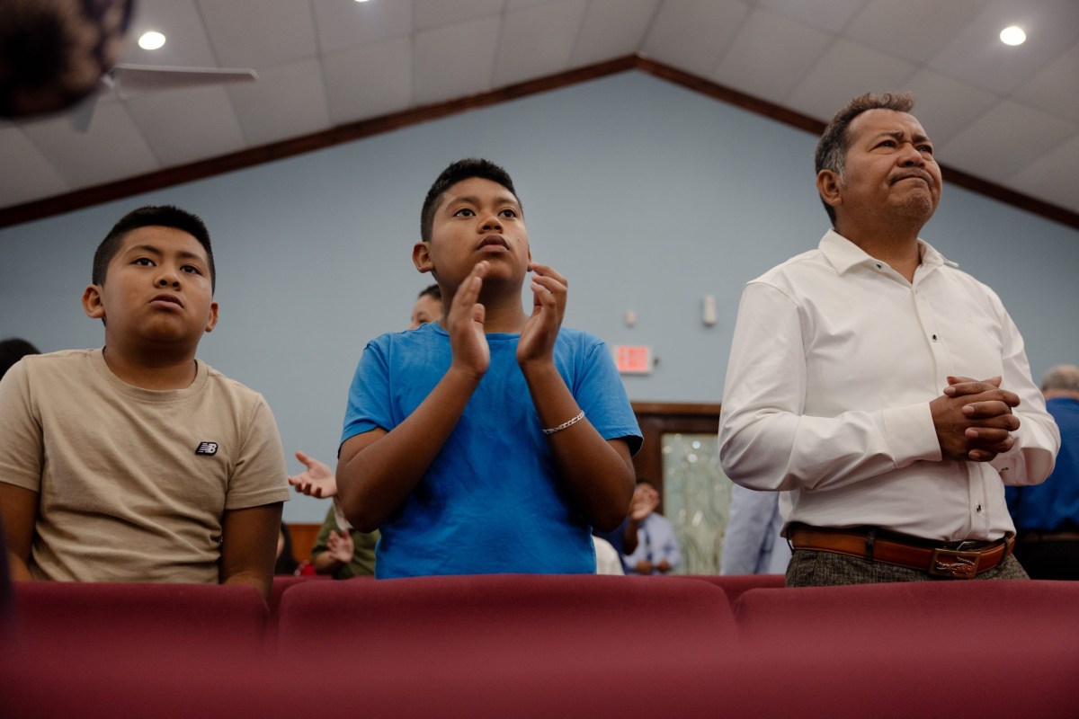 José Avila and his sons, Jeremiah (left) and Issac (middle), attend service at their Houston church in June. José is a devout Christian, finding solace in his faith while his wife was detained.
