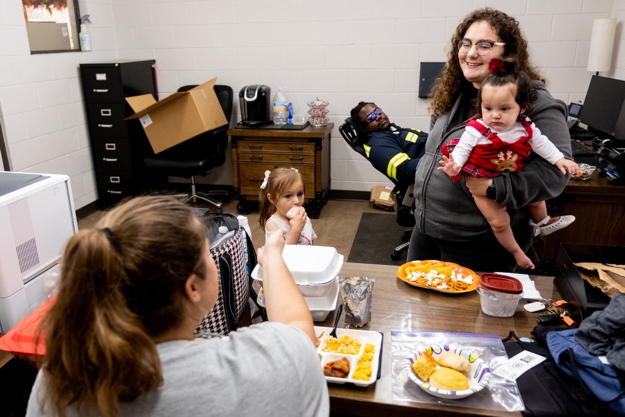 City of Tyler employee Teresa Tudor and her children Cecilia Tudor, 4, and Natalia Hurtado, 8 months, visit with her coworkers Gina Elzea and Michael Runnels at the Tyler Water Utilities service center on Nov. 21, 2025.