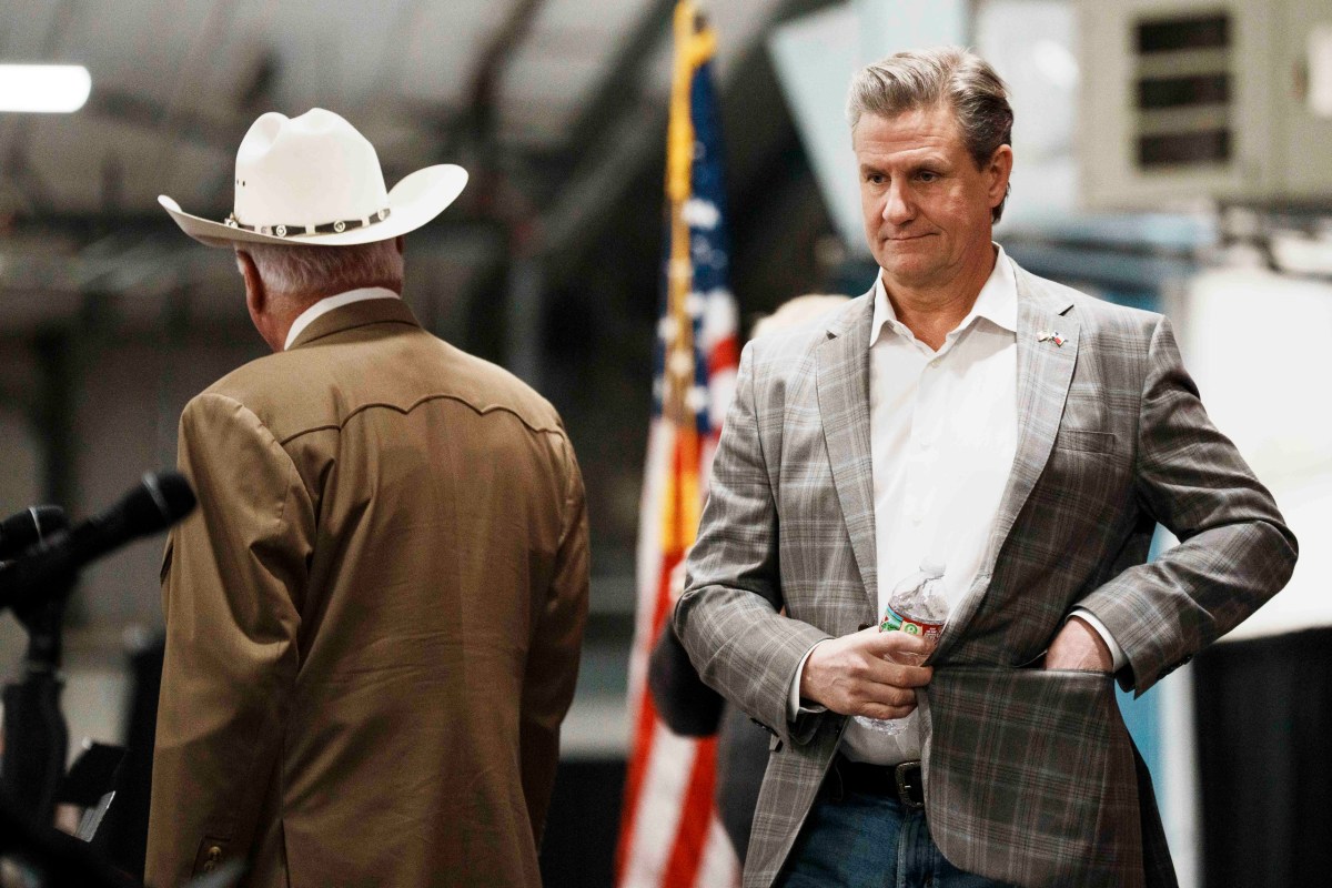 Candidate for Texas Agriculture Commissioner, Nate Sheets, takes the stage next to incumbent Sid Miller, during a Texas Republican candidate debate forum at the Civic Center in Canton on Jan. 17, 2026.