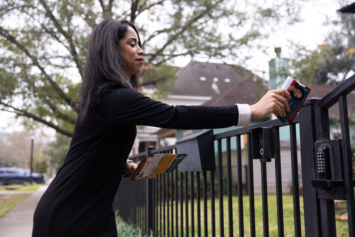 Amanda Edwards leaves a campaign flyer at a Heights neighborhood home while block-walking on Jan. 23, 2026, in Houston.