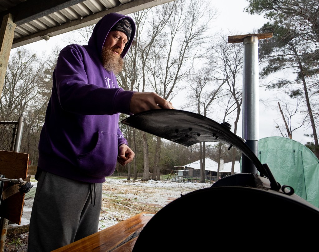 Dustin Arnn smoked brisket outside of his Longview home on Saturday morning, preparing to make chili.