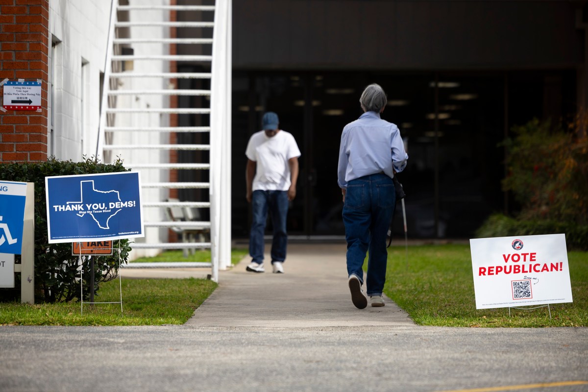 A volunteer and a voter exit and enter the polling location at Westbury Baptist Church during primary election day on Tuesday, March 3, 2026, in Houston.