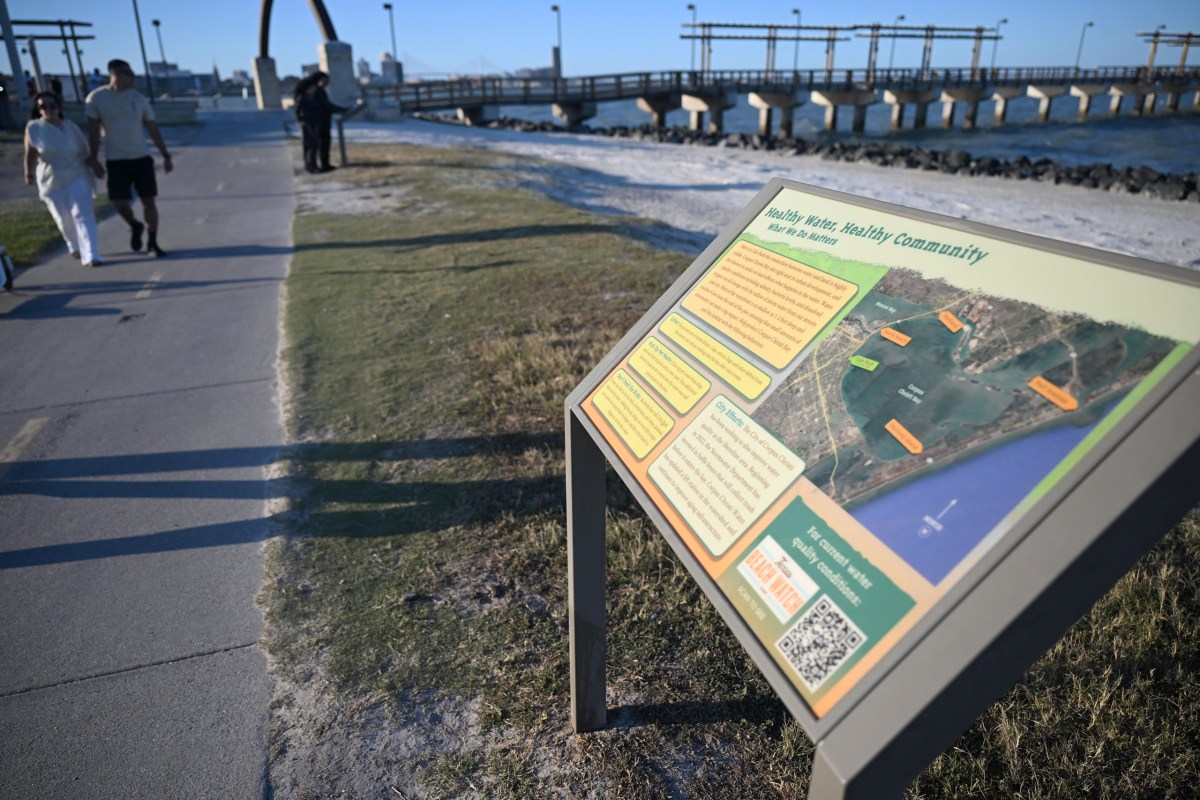 A sign reading "Healthy Water, Healthy Community" sits next to a hike and bike path in Cole Park in Corpus Christi on March 19, 2026.