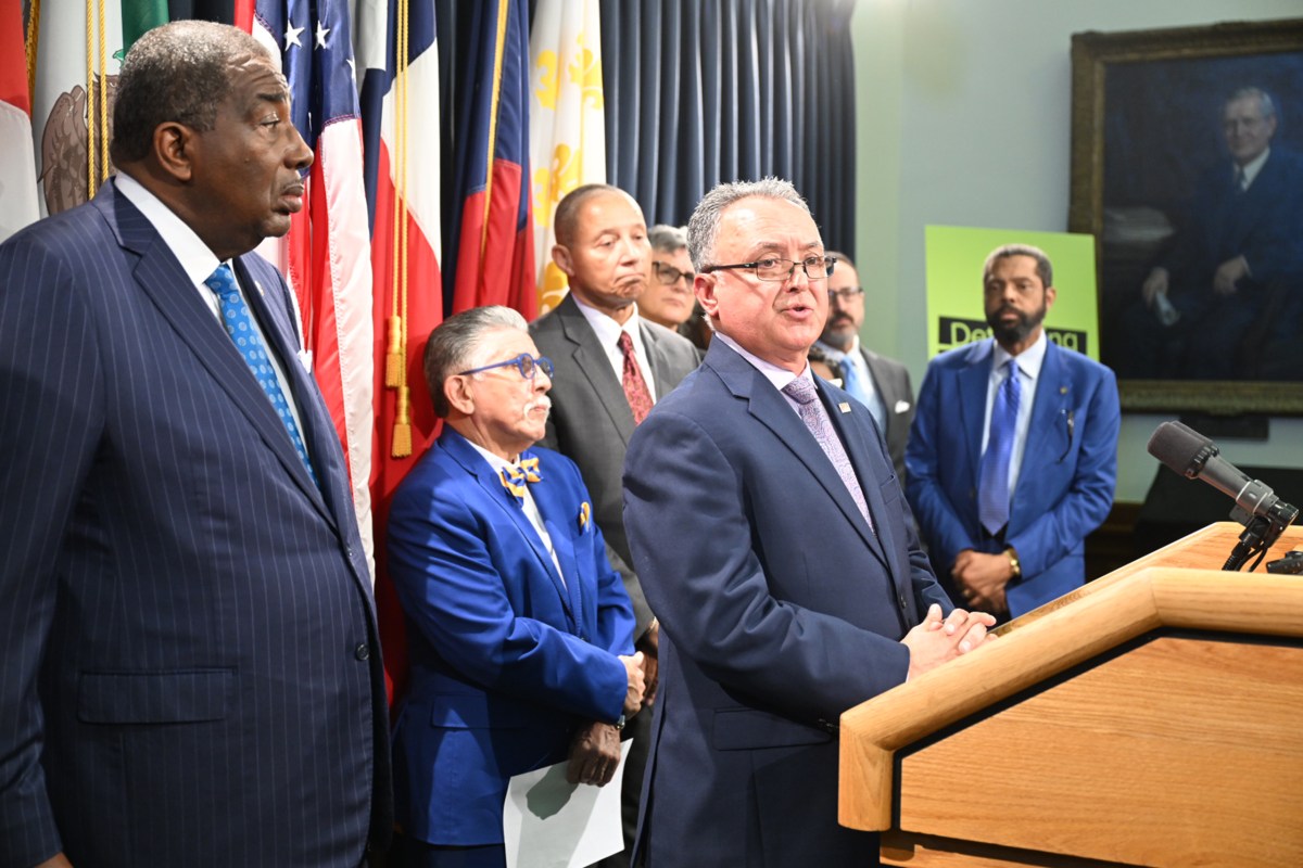 State Sen. Royce West, D-Dallas, left, listens as Ipsum General Contractors owner Ruben Mercado Jr. speaks at a press conference about a lawsuit against the state comptroller's office, at the Capitol in Austin on Monday, March 2, 2026.