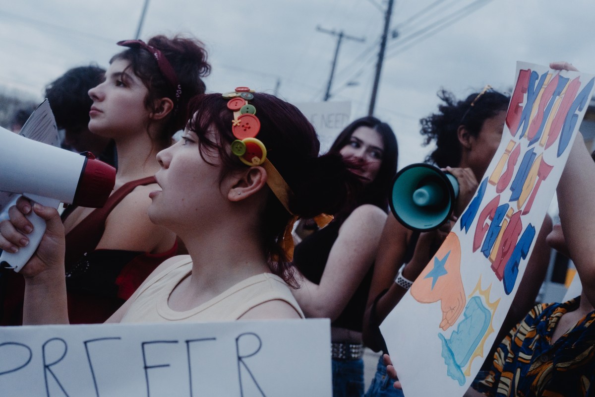 Protesters, many of them high school students, show up in front of a site believed to be an ICE detention facility on Algreg Street in Pflugerville on Feb. 13, 2026.