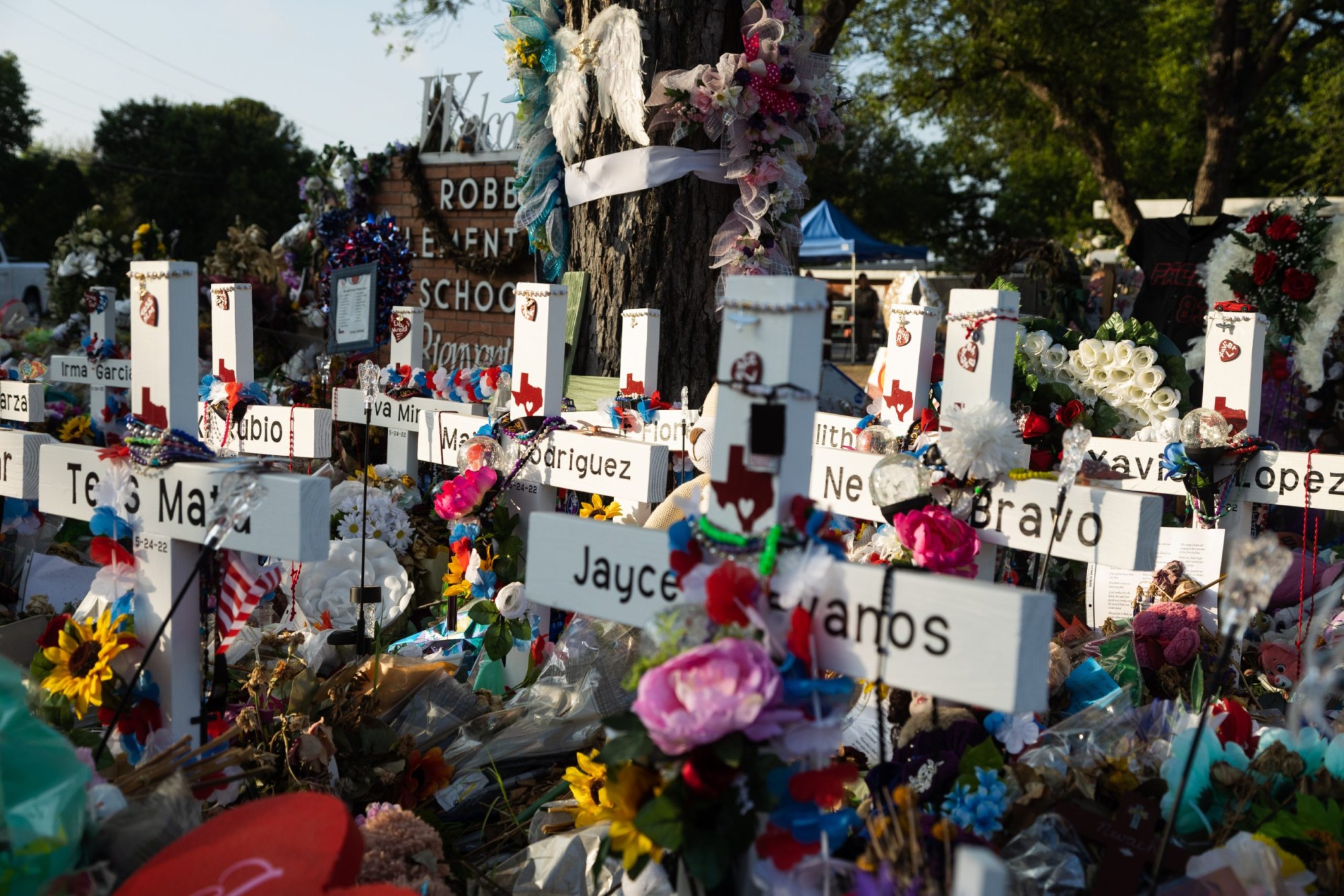 Hundreds of flowers, toys and candles surround crosses memorializing the 21 victims of the school shooting at Robb Elementary in Uvalde, Texas, on June 9, 2022.