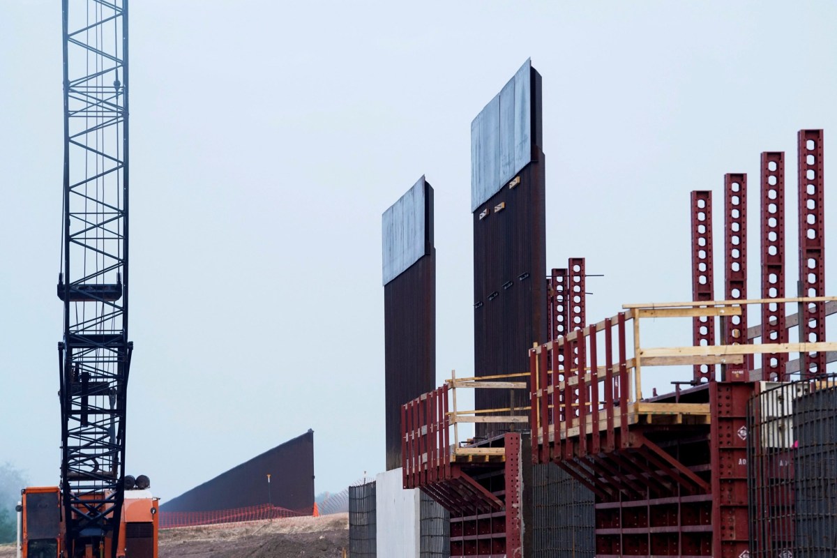 The existing border wall (at left) as new segments of the border wall are erected in Texas near Donna in 2019.